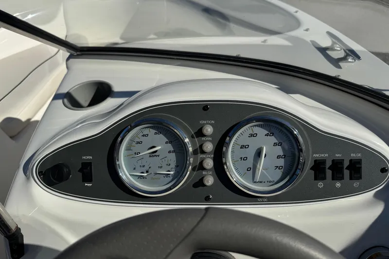 Slide: The Image of 2013 Bayliner 160 Bowrider dashboard with speedometer and control switches. - 8