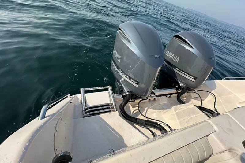 Slide: The Image of 2008 Grady White Express boat with twin Yamaha V8 outboard engines on open water. - 18