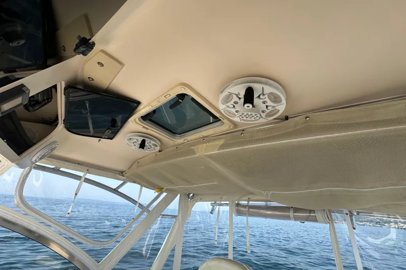 Slide: The Image of 2008 Grady White Express boat interior with speaker and hatch, overlooking the ocean. - 22