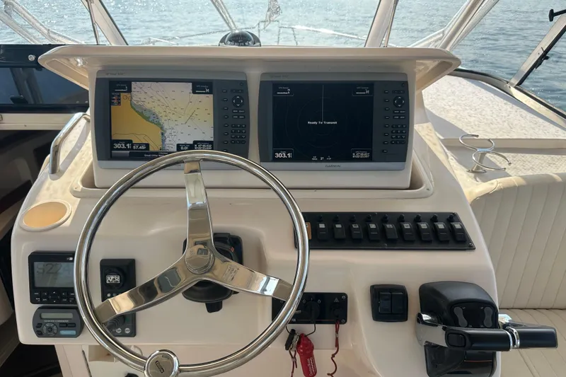 Slide: The Image of 2008 Grady White Express boat helm with dual Garmin displays and steering wheel. - 24