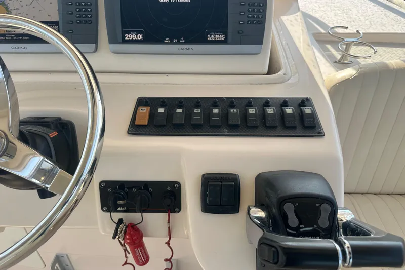 Slide: The Image of 2008 Grady White Express boat dashboard with Garmin navigation and control switches. - 29
