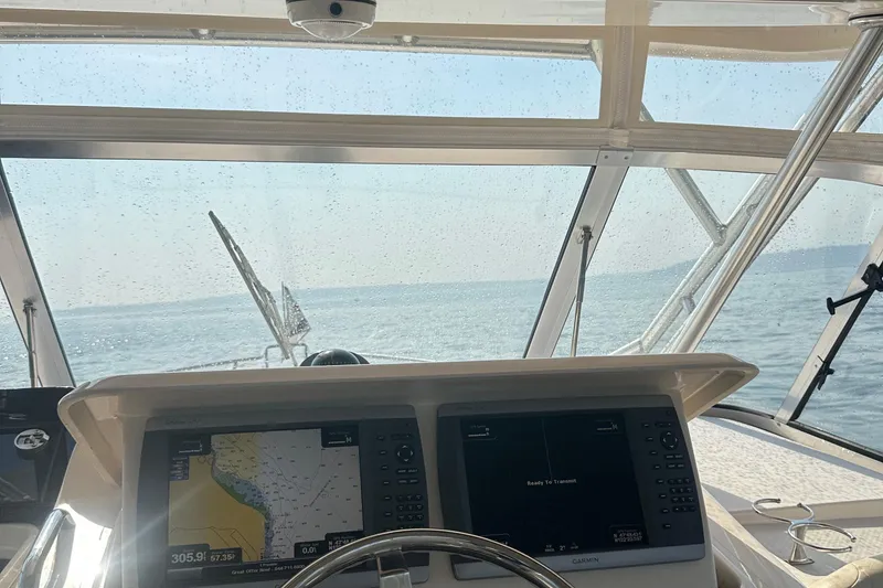 Slide: The Image of 2008 Grady White Express boat dashboard with navigation screens, ocean view through windshield. - 30
