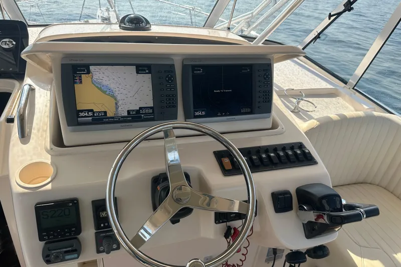Slide: The Image of 2008 Grady White Express boat helm with dual Garmin displays and steering wheel. - 31
