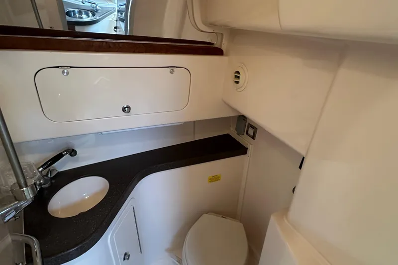 Slide: The Image of 2008 Grady White Express boat bathroom with sink, toilet, and storage cabinet. - 34