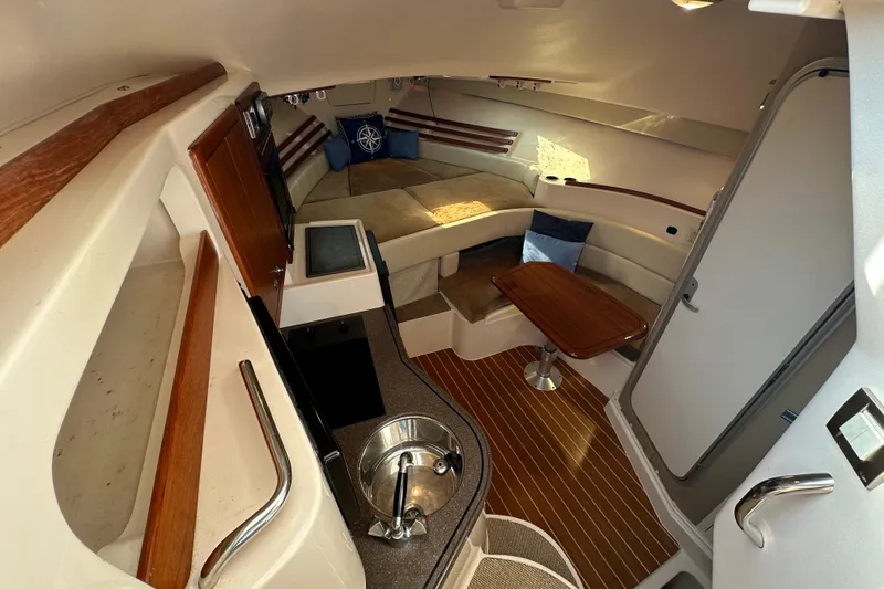 Slide: The Image of 2008 Grady White Express boat interior with seating, table, and kitchenette. - 35