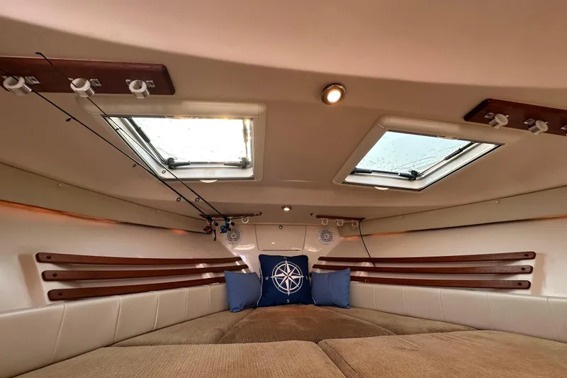 Slide: The Image of 2008 Grady White Express cabin interior with skylights and fishing rod holders. - 36