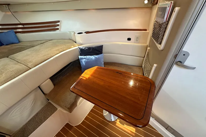 Slide: The Image of 2008 Grady White Express cabin interior with wooden table and cushioned seating. - 38