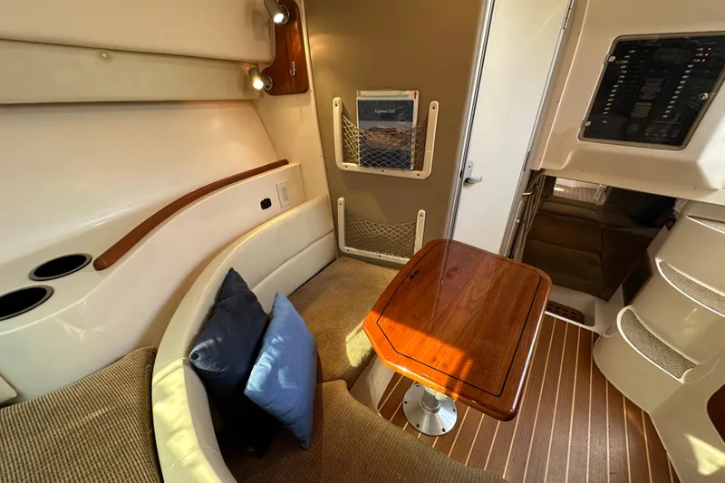 Slide: The Image of 2008 Grady White Express cabin interior with seating, table, and wood accents. - 39