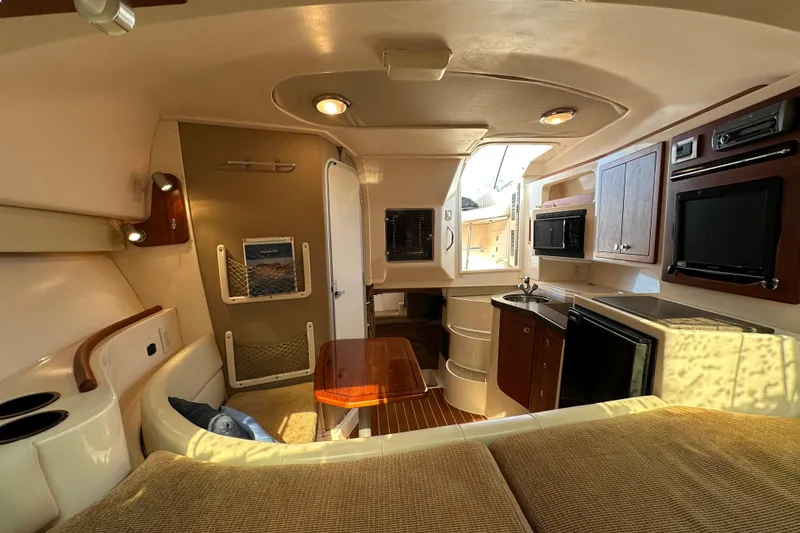 Slide: The Image of 2008 Grady White Express boat interior with kitchenette, seating, and modern amenities. - 40