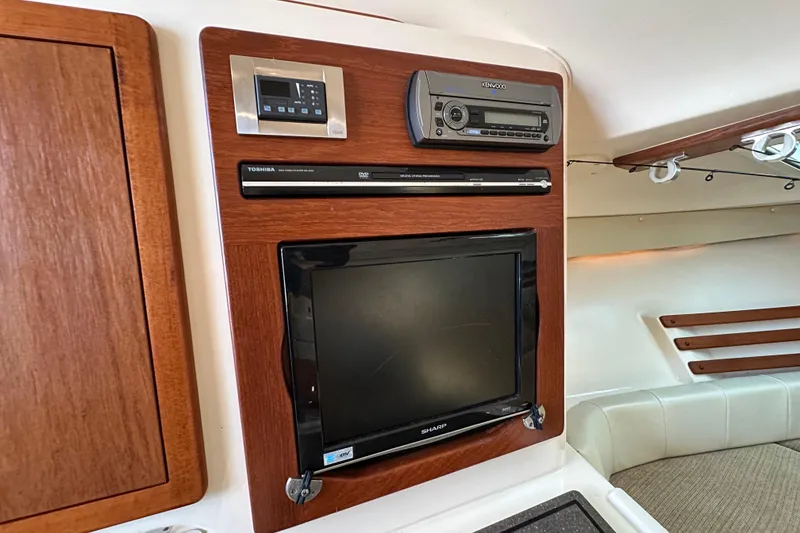 Slide: The Image of 2008 Grady White Express interior with TV, DVD player, and stereo system. - 44