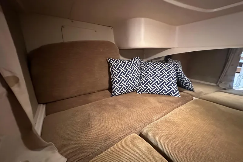 Slide: The Image of 2008 Grady White Express cabin interior with patterned cushions on a beige seating area. - 47