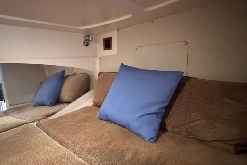 Slide: The Image of Interior cabin of 2008 Grady White Express boat with blue and brown cushions. - 48