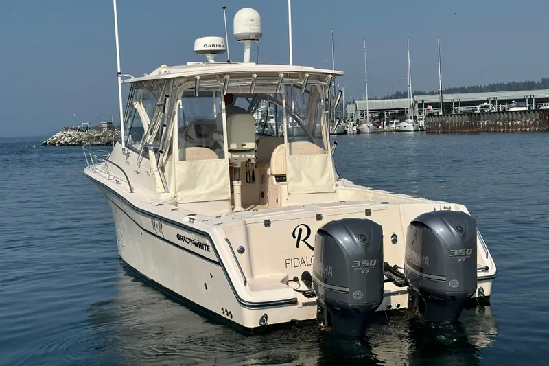 Slide: The Image of 2008 Grady White Express boat with twin Yamaha 350 engines docked in marina. - 6