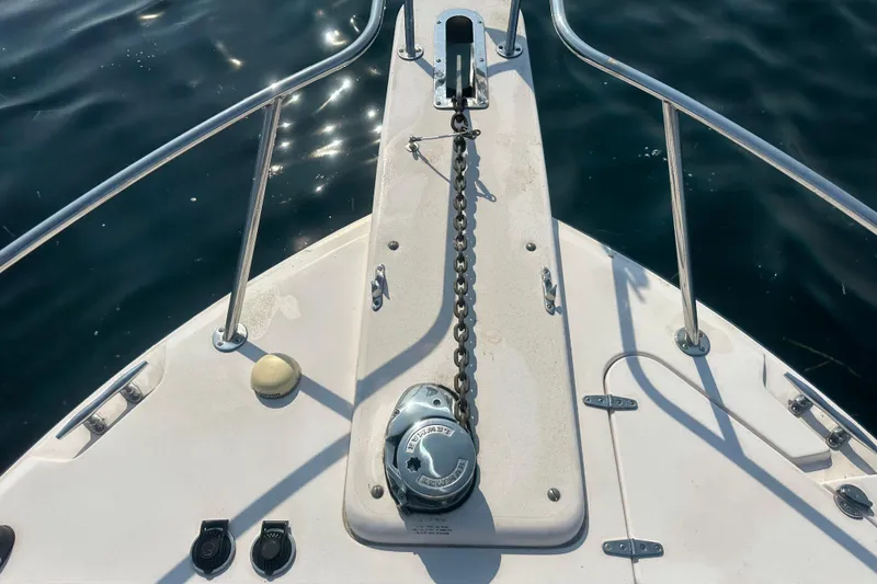 Slide: The Image of 2008 Grady White Express boat bow with anchor chain over calm water. - 8
