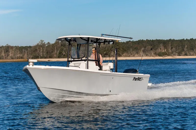 Slide: The Image of Manufacturer Provided Image: 2026 Parker 230 Coastal Elite boat cruising on a serene lake with forested shoreline. - 15