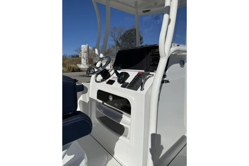 Slide: The Image of 2026 Parker 230 Coastal Elite boat console with steering wheel and controls. - 4