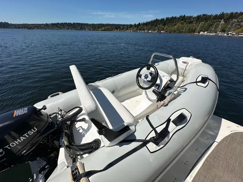 Slide: The Image of Inflatable boat with Tohatsu motor on calm lake, near 2004 Sea Ray 340 Sundancer. - 13