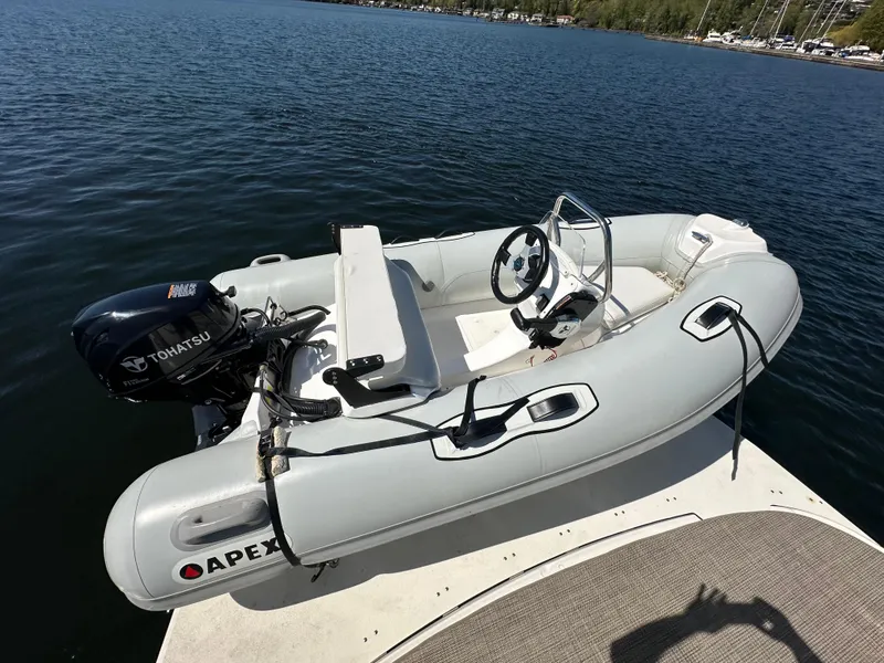 Slide: The Image of Inflatable boat with Tohatsu motor on a dock, near a 2004 Sea Ray 340 Sundancer. - 14