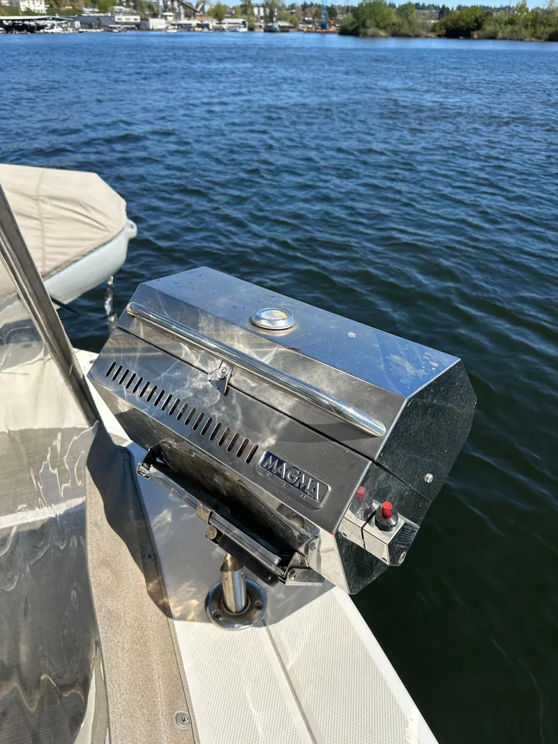 Slide: The Image of Stainless steel grill on a 2004 Sea Ray 340 Sundancer boat by the water. - 15
