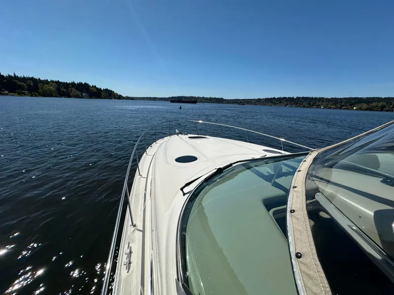 Slide: The Image of 2004 Sea Ray 340 Sundancer cruising on a sunny lake with clear blue skies. - 18