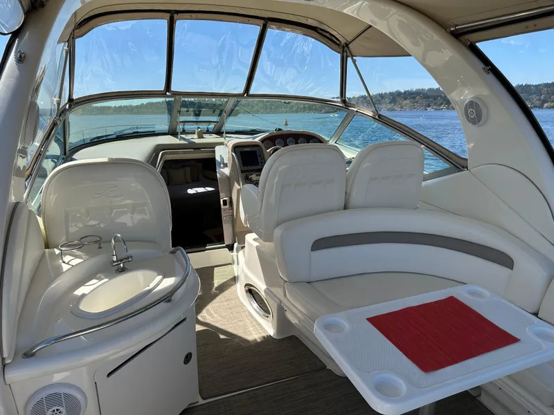 Slide: The Image of 2004 Sea Ray 340 Sundancer interior with seating, helm, and water view. - 22