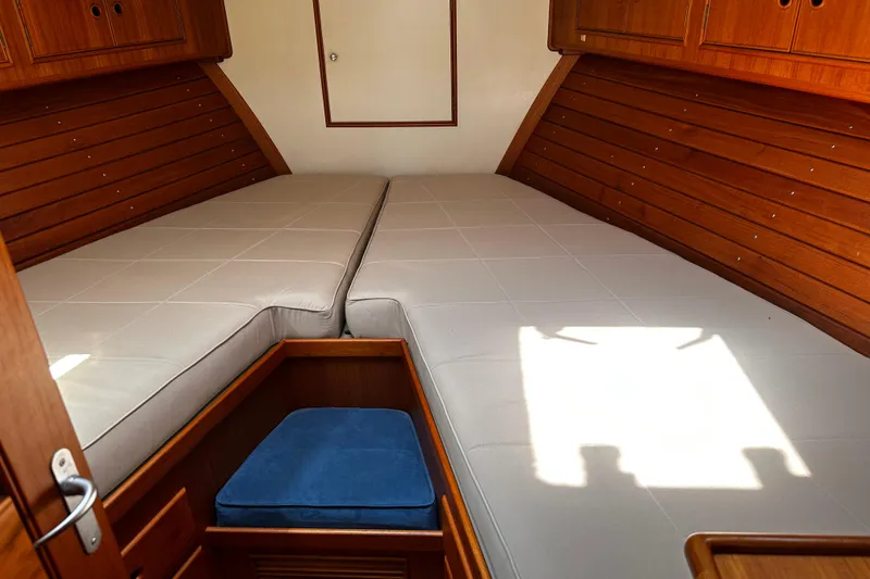 Slide: The Image of Cozy cabin interior of 1995 Grand Banks 38 Eastbay EX with twin beds and wooden finish. - 11