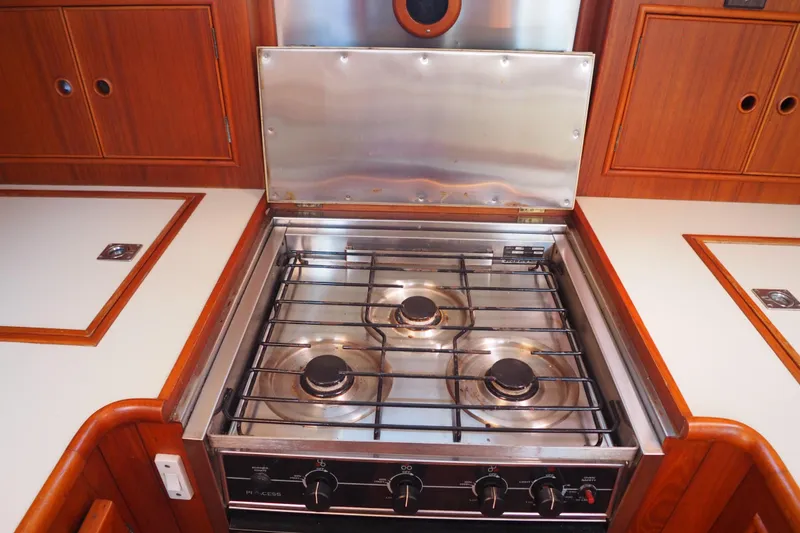 Slide: The Image of Stove in 1995 Grand Banks 38 Eastbay EX yacht kitchen, featuring wooden cabinetry. - 15