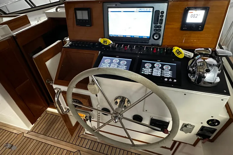 Slide: The Image of 1995 Grand Banks 38 Eastbay EX helm with navigation screens and steering wheel. - 2