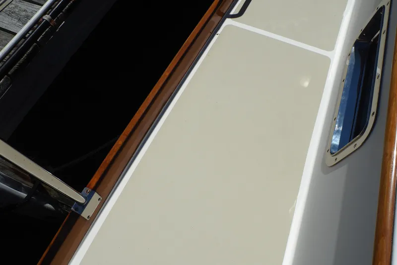 Slide: The Image of 1995 Grand Banks 38 Eastbay EX boat deck with wood trim and window detail. - 20