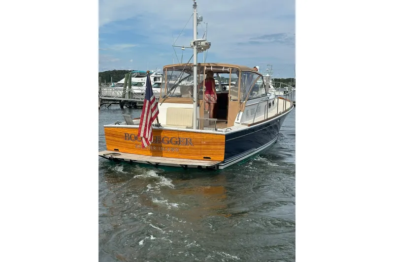 Slide: The Image of 1995 Grand Banks 38 Eastbay EX boat on water, rear view with American flag. - 35