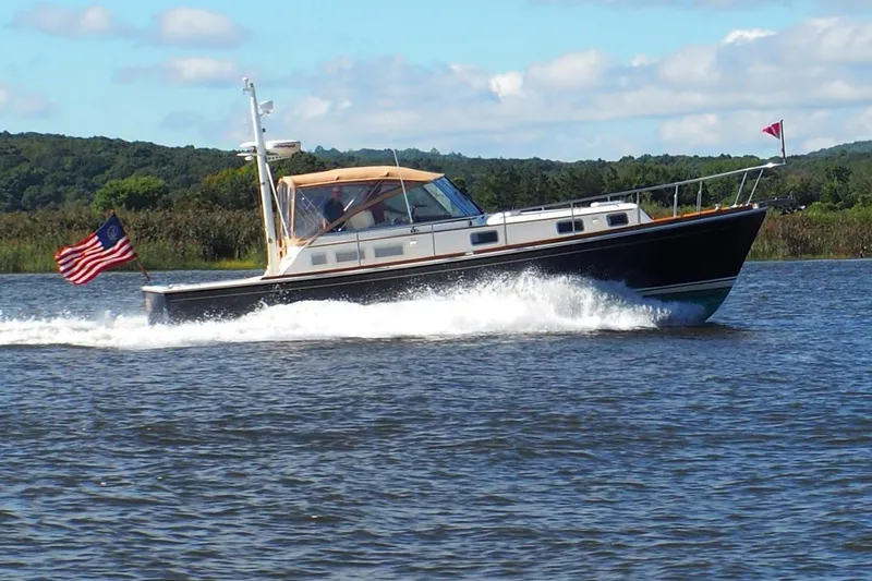 Slide: The Image of 1995 Grand Banks 38 Eastbay EX cruising on a river. - 36