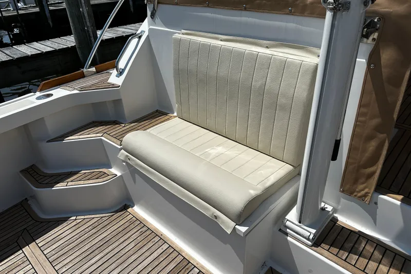 Slide: The Image of 1995 Grand Banks 38 Eastbay EX boat seating with teak flooring and white upholstery. - 5