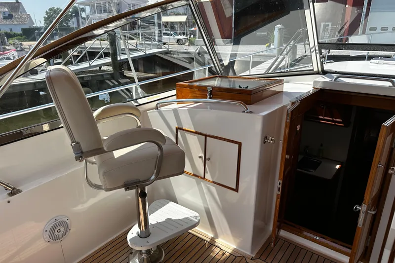 Slide: The Image of 1995 Grand Banks 38 Eastbay EX yacht interior with helm seat and cabin entrance. - 7
