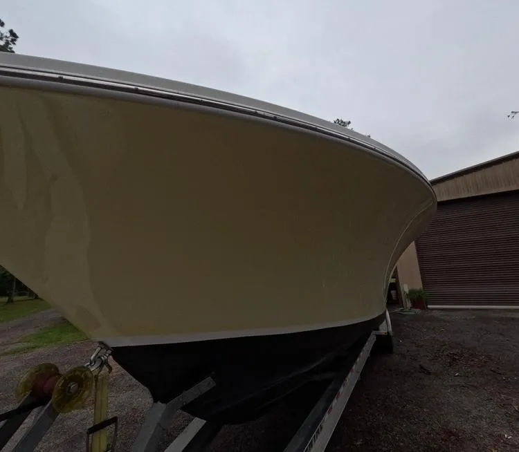 Slide: The Image of 2013 Regulator 34 Center Console boat on trailer, side view. - 11