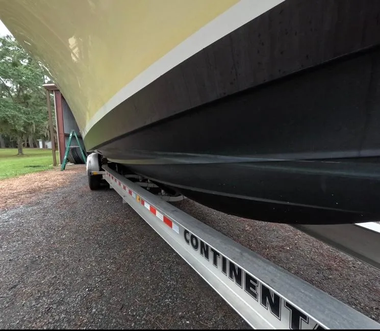 Slide: The Image of 2013 Regulator 34 Center Console boat on trailer, side view. - 13