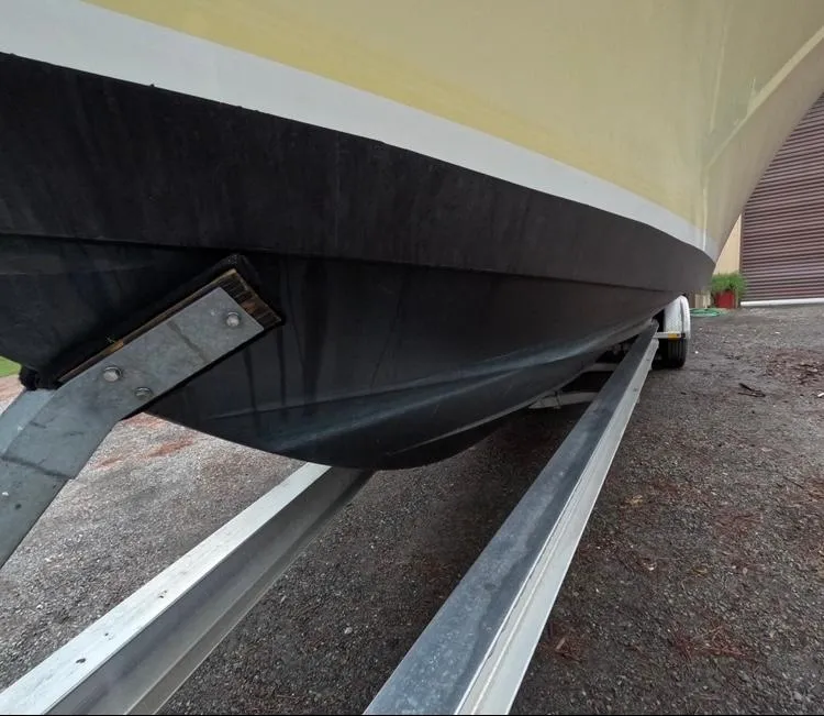 Slide: The Image of 2013 Regulator 34 Center Console boat on trailer, close-up view of hull. - 15