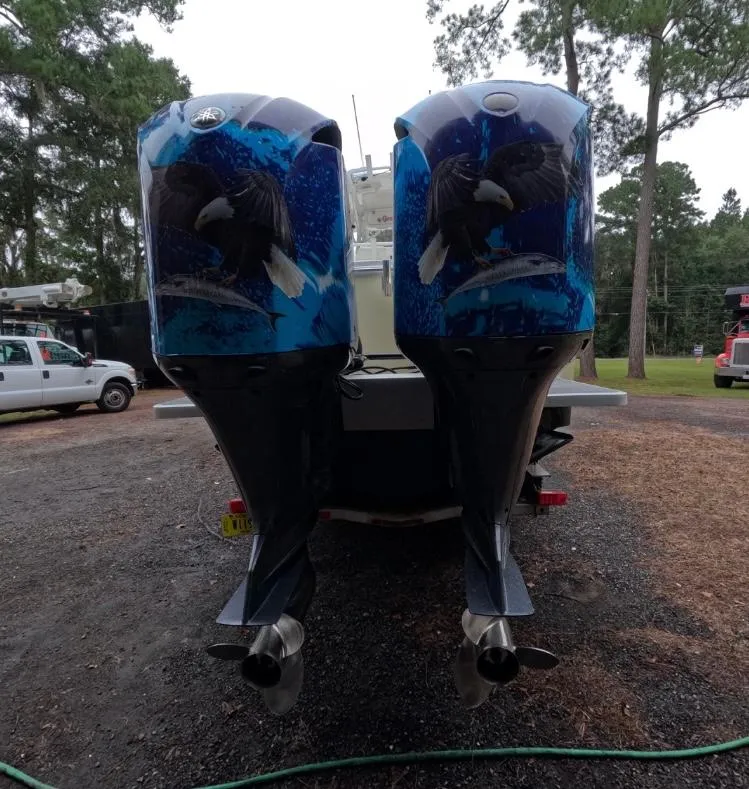 Slide: The Image of 2013 Regulator 34 Center Console with custom eagle-themed outboard motors. - 18
