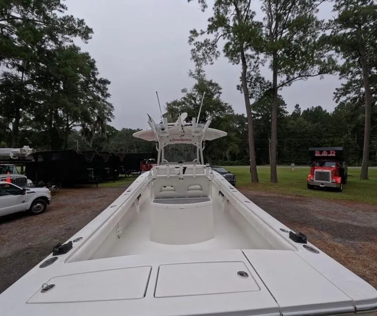 Slide: The Image of 2013 Regulator 34 Center Console boat in a wooded outdoor setting. - 23