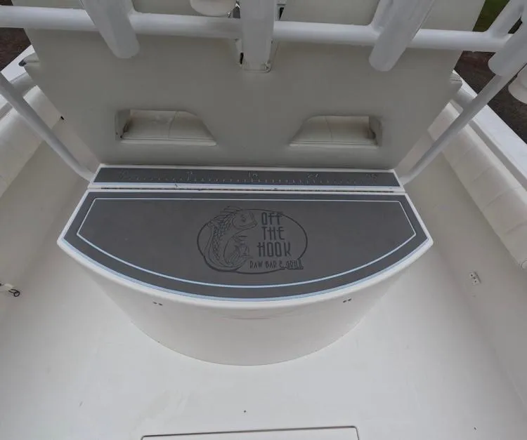 Slide: The Image of 2013 Regulator 34 Center Console boat deck with "Off the Hook" logo. - 25