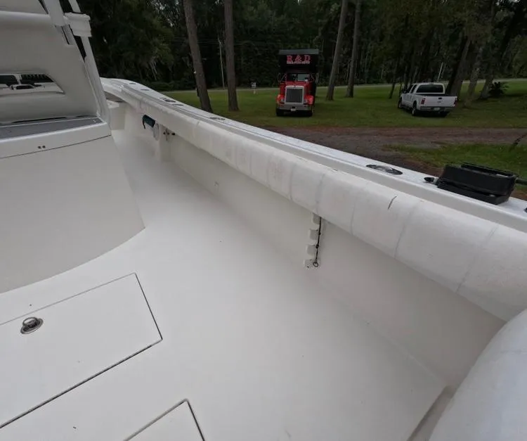Slide: The Image of 2013 Regulator 34 Center Console boat interior, featuring spacious deck and storage compartments. - 28