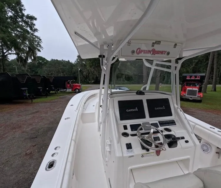 Slide: The Image of 2013 Regulator 34 Center Console boat with Garmin navigation, parked outdoors. - 29