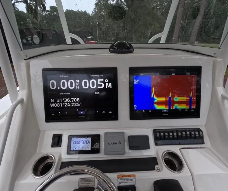 Slide: The Image of 2013 Regulator 34 Center Console dashboard with navigation and sonar displays. - 33