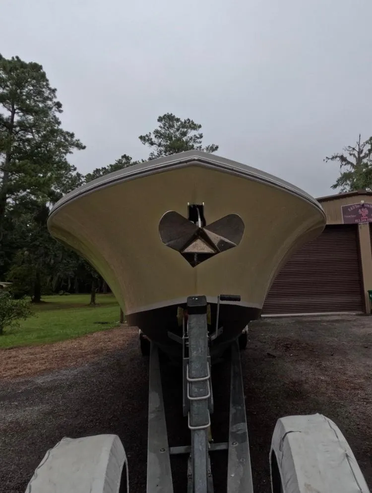 Slide: The Image of 2013 Regulator 34 Center Console boat on trailer, front view, outdoors. - 4