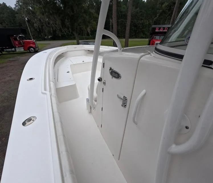 Slide: The Image of 2013 Regulator 34 Center Console boat, white deck view, outdoor setting. - 42