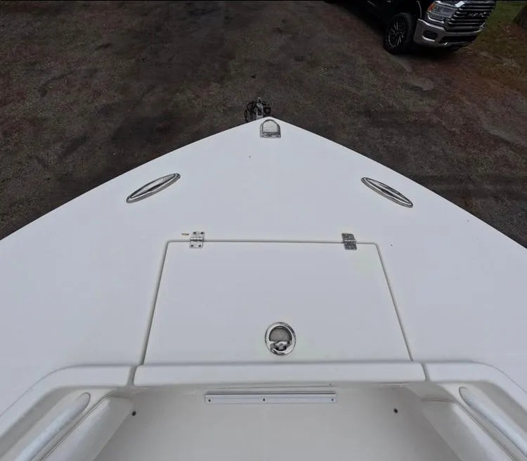 Slide: The Image of 2013 Regulator 34 Center Console boat bow view with storage hatch. - 47