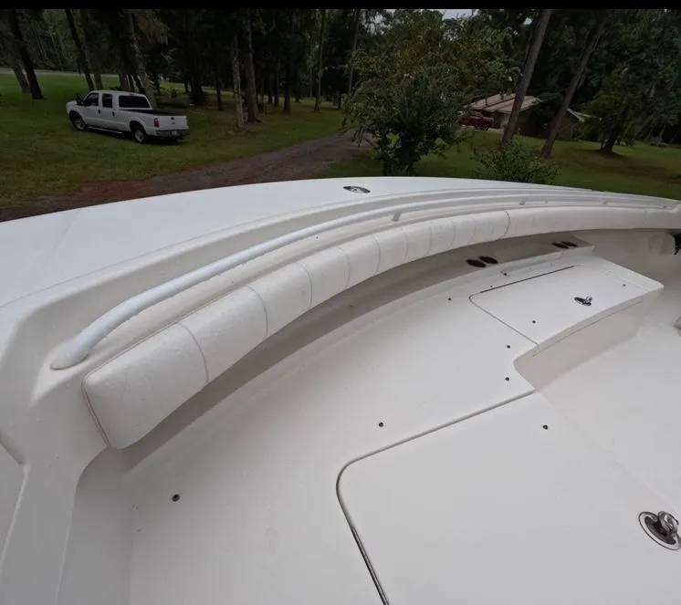Slide: The Image of 2013 Regulator 34 Center Console boat interior with white cushioned seating. - 48