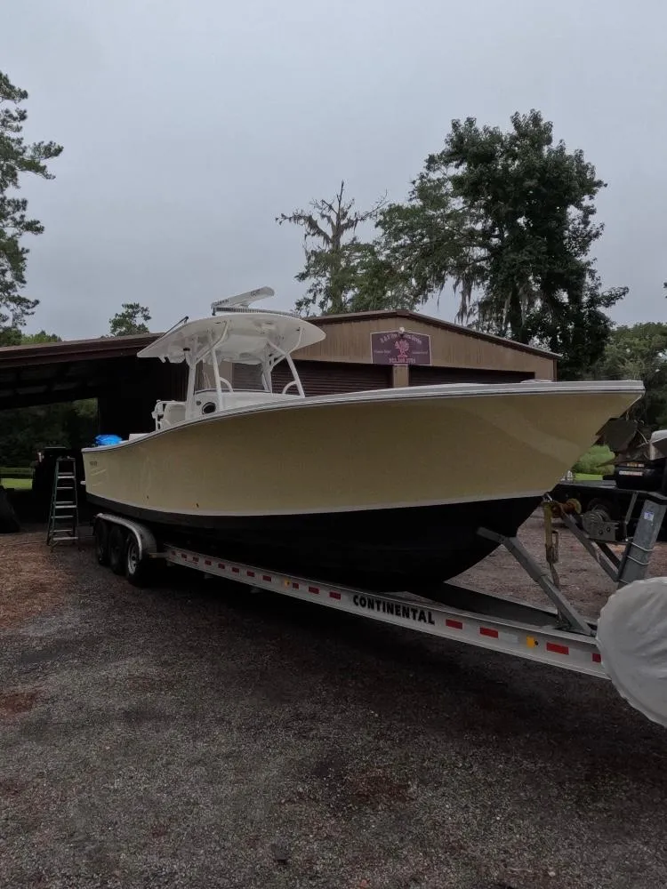 Slide: The Image of 2013 Regulator 34 Center Console boat on trailer, parked outdoors. - 6