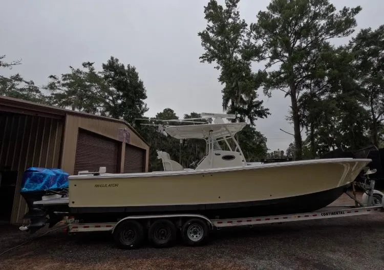 Slide: The Image of 2013 Regulator 34 Center Console boat on trailer near storage building. - 8