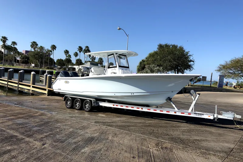 The Image of 2018 Sea Hunt Gamefish 30 on trailer at boat launch, sunny day. - 0