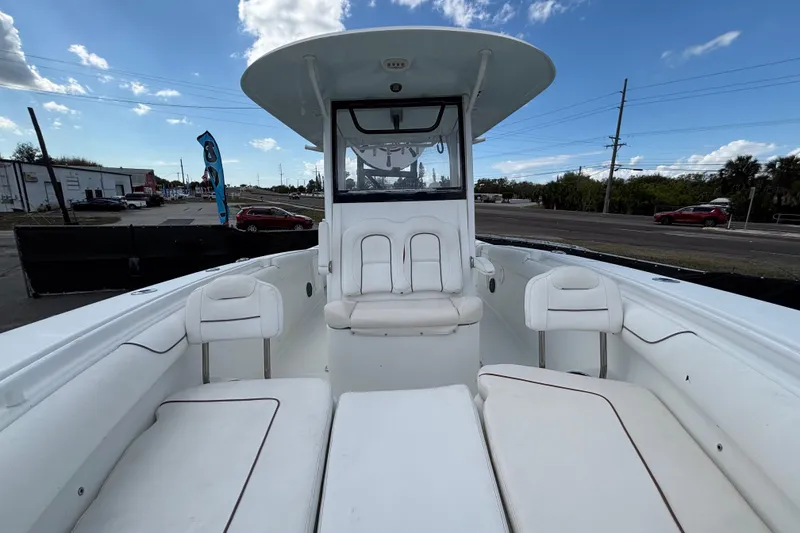 Slide: The Image of 2018 Sea Hunt Gamefish 30 Forward Seating boat with white interior and clear sky background. - 103